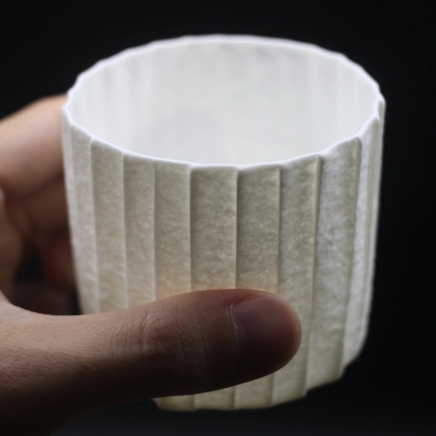 Kilnora Lumora Stonefold Series 250 ml porcelain cup with natural stone-folded facets and delicate light-capturing translucence.