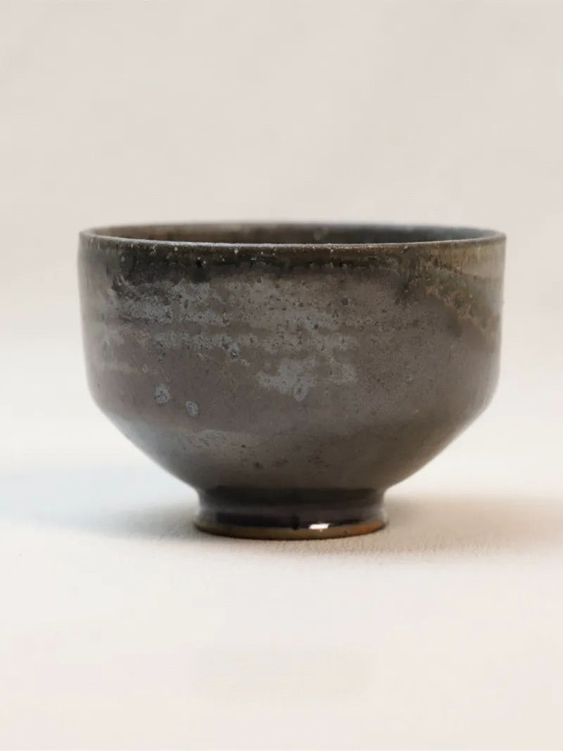 Kilnora Chihiro Series soda-fired cup with natural soda ash glaze variations on porcelain.