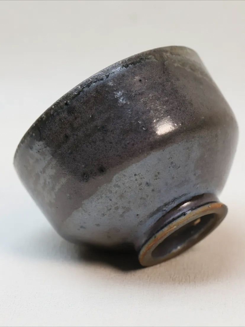 Kilnora Chihiro Series soda-fired cup with natural soda ash glaze variations on porcelain.