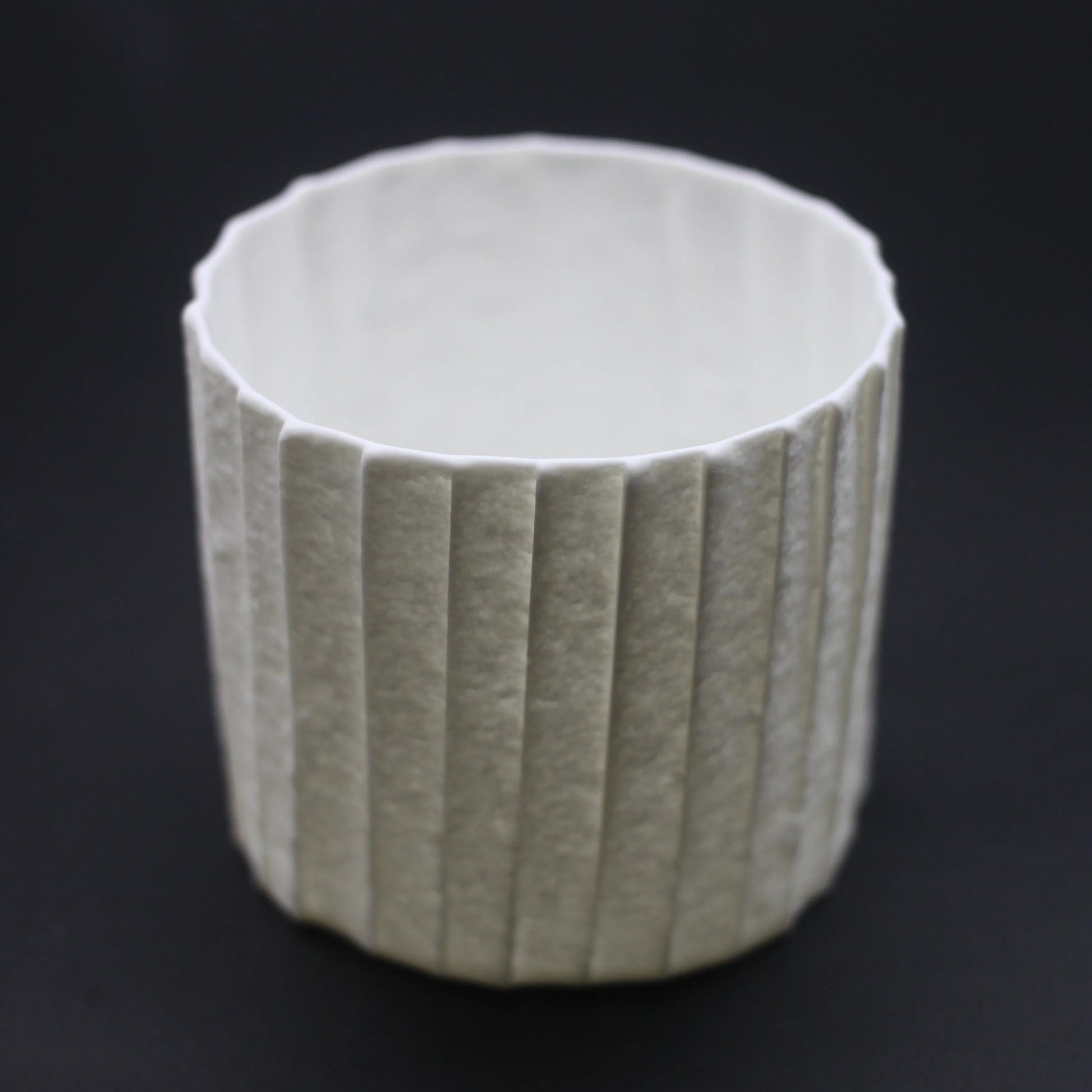 Kilnora Lumora Stonefold Series 250 ml porcelain cup with natural stone-folded facets and delicate light-capturing translucence.