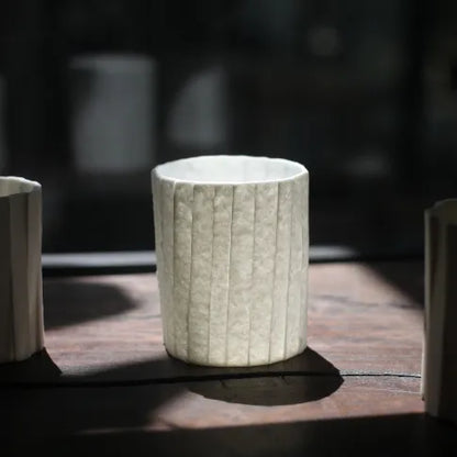 Kilnora Lumora Stonefold Series 180 ml porcelain cup featuring handcrafted rock-fold textures and soft translucence.