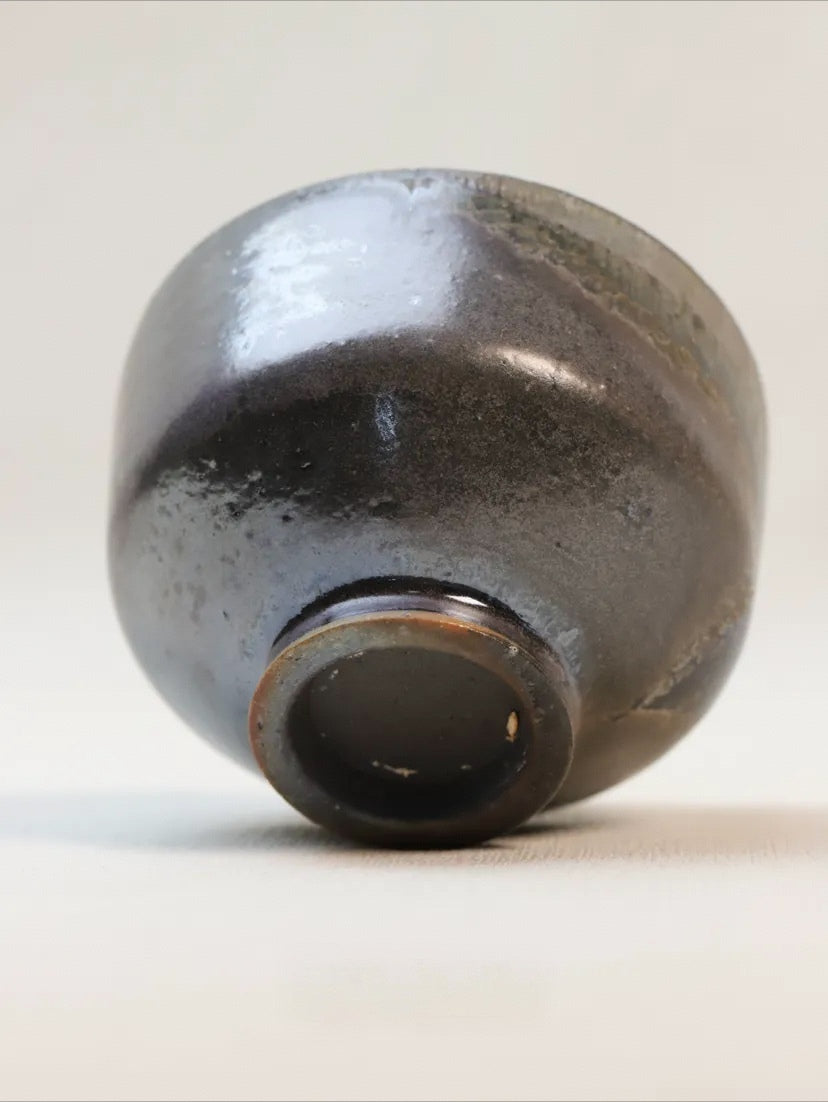 Kilnora Chihiro Series soda-fired cup with natural soda ash glaze variations on porcelain.