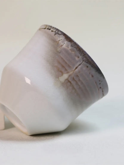 Kilnora Chihiro Series wood-fired porcelain cup with gentle curves and flame-kissed finish.