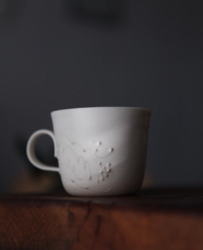 Kilnora Sōng Dandelion Series matte white handled coffee cup featuring custom slip decoration and soft matte finish
