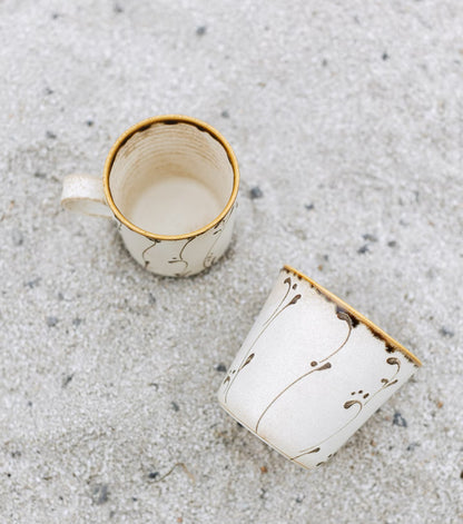 Kilnora Sōng Amber Series ceramic Chyongku cup with warm amber glaze and hand-painted slip motifs