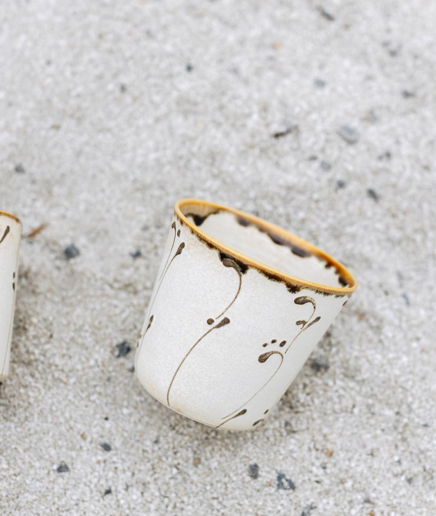 Kilnora Sōng Amber Series ceramic Chyongku cup with warm amber glaze and hand-painted slip motifs