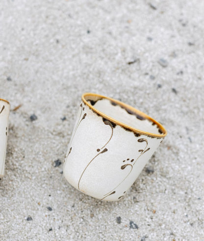 Kilnora Sōng Amber Series ceramic Chyongku cup with warm amber glaze and hand-painted slip motifs