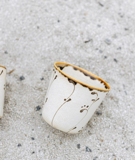 Kilnora Sōng Amber Series ceramic Chyongku cup with warm amber glaze and hand-painted slip motifs