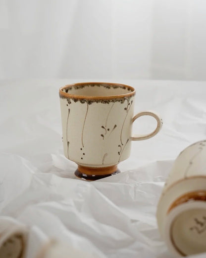 Kilnora Sōng Amber Series coffee cup featuring rich amber glaze and delicate relief patterns