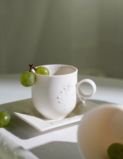 Kilnora Sōng Dandelion Series matte white ceramic cup with freehand slip motifs and mineral powder accents