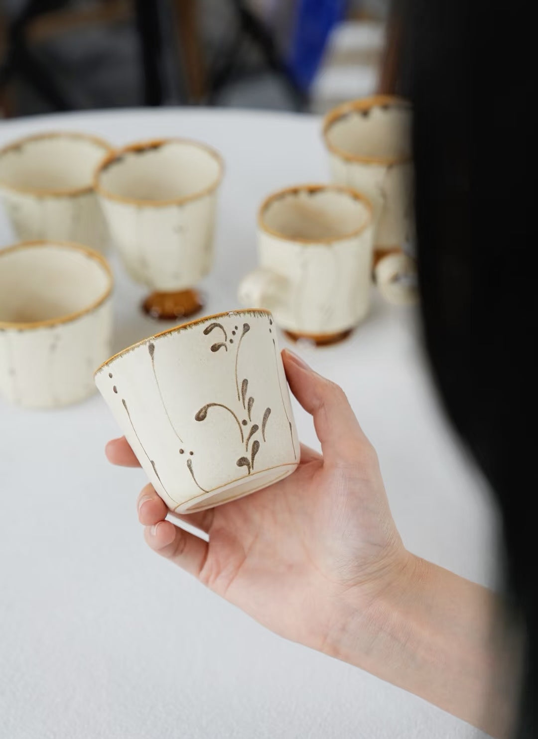 Kilnora Sōng Amber Series ceramic Chyongku cup with warm amber glaze and hand-painted slip motifs