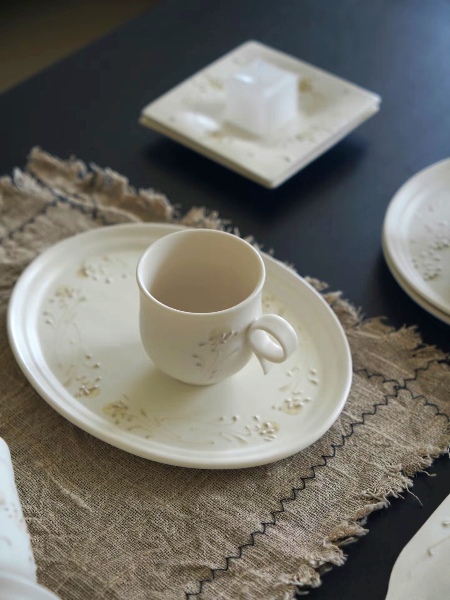 Kilnora Sōng Dandelion Series matte white ceramic cup with freehand slip motifs and mineral powder accents