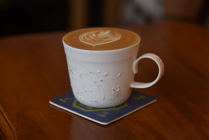 Kilnora Sōng Dandelion Series matte white handled coffee cup featuring custom slip decoration and soft matte finish