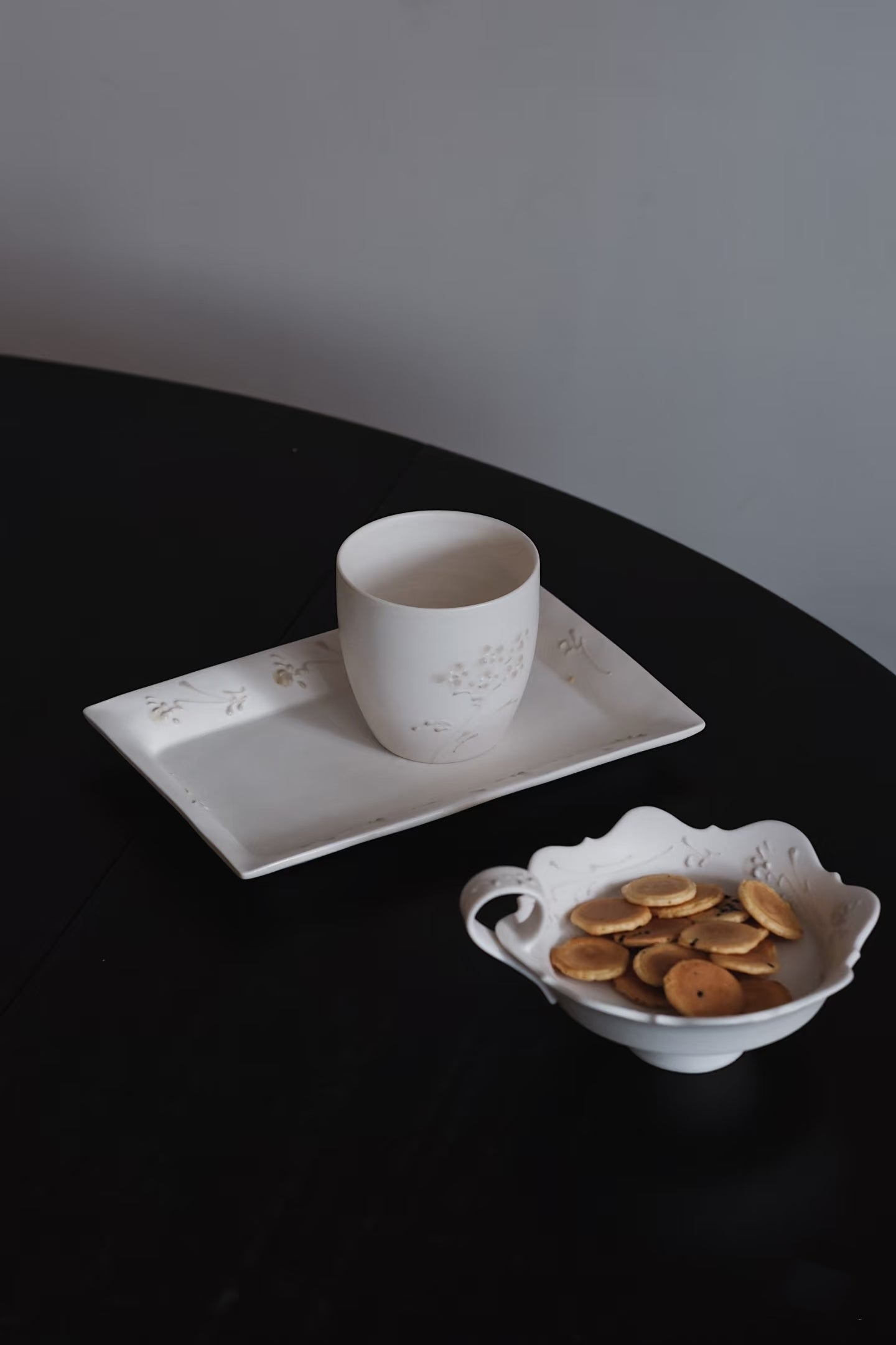 Kilnora Sōng Dandelion Series matte white ceramic cup showcasing delicate relief and minimalist design