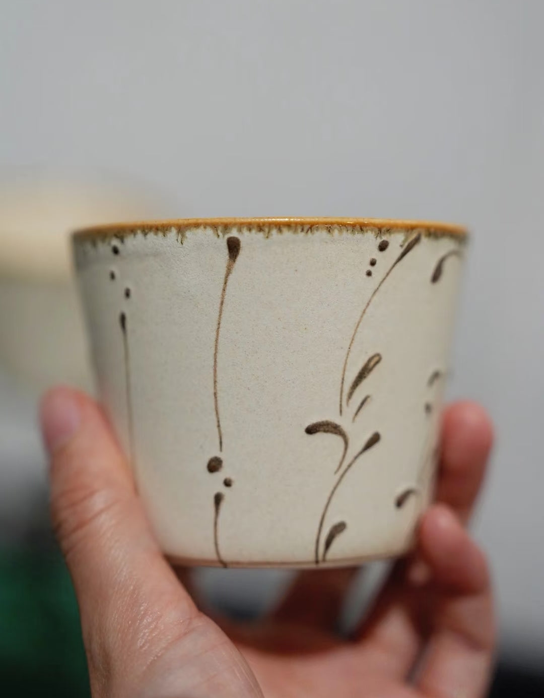 Kilnora Sōng Amber Series ceramic Chyongku cup with warm amber glaze and hand-painted slip motifs