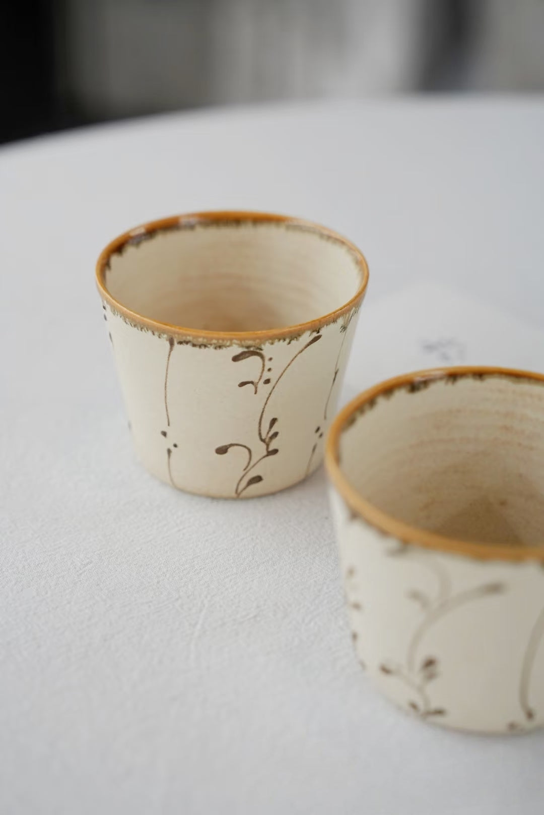 Kilnora Sōng Amber Series ceramic Chyongku cup with warm amber glaze and hand-painted slip motifs