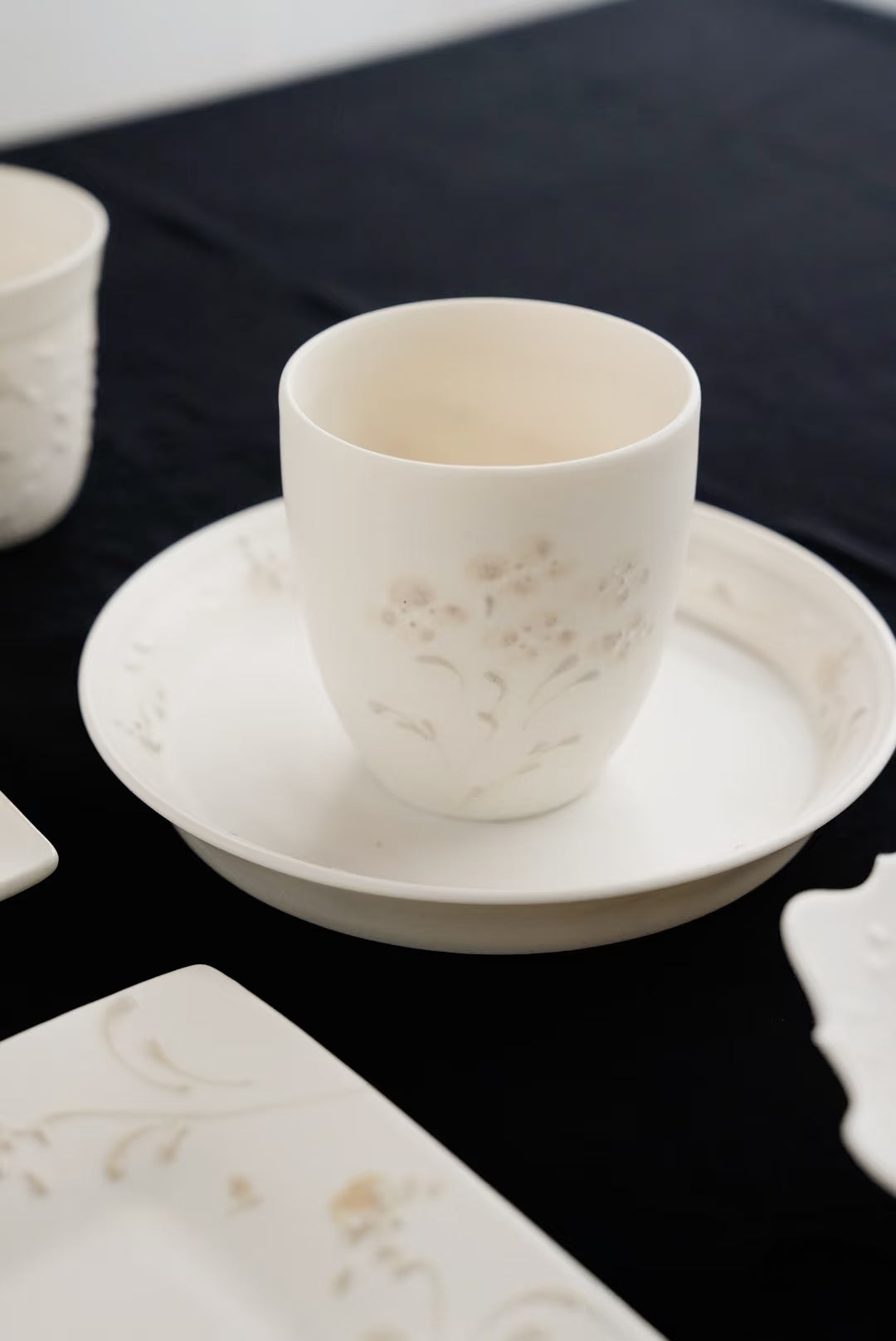 Kilnora Sōng Dandelion Series matte white ceramic cup showcasing delicate relief and minimalist design