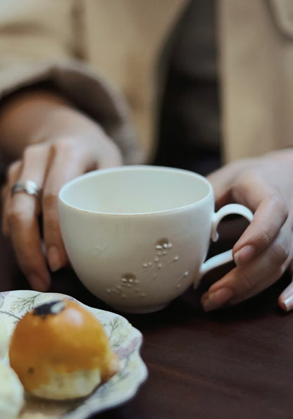Kilnora Sōng Dandelion Series matte white coffee cup with handcrafted slip patterns and subtle glaze variations