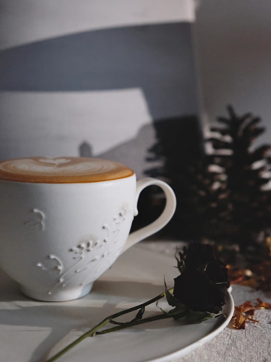 Kilnora Sōng Dandelion Series matte white coffee cup with handcrafted slip patterns and subtle glaze variations