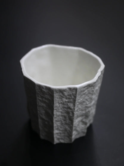 Kilnora Lumora Sekisen Series 180 ml porcelain cup with folded stone-inspired form and translucent paper-thin walls.
