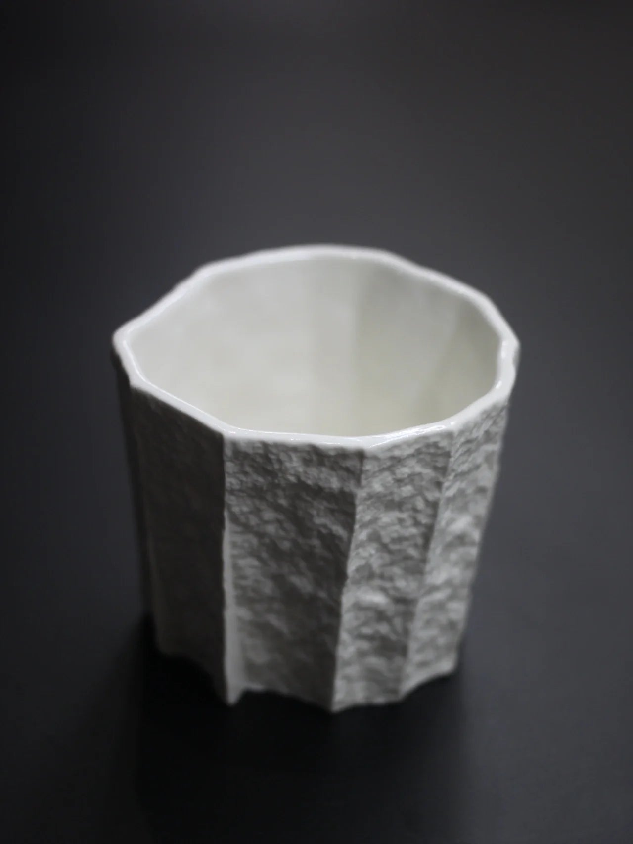 Kilnora Lumora Sekisen Series 180 ml porcelain cup with folded stone-inspired form and translucent paper-thin walls.