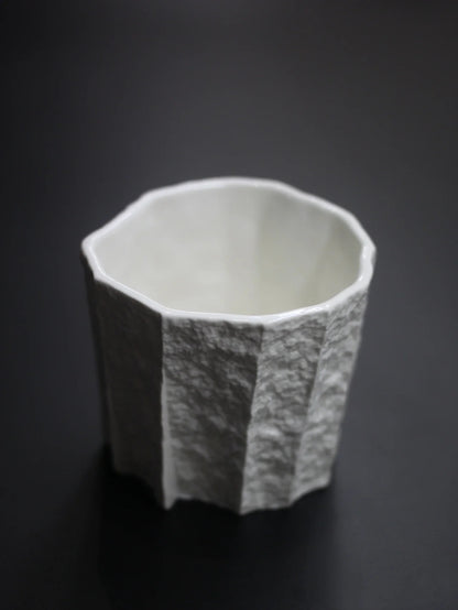 Kilnora Lumora Sekisen Series 180 ml porcelain cup with folded stone-inspired form and translucent paper-thin walls.