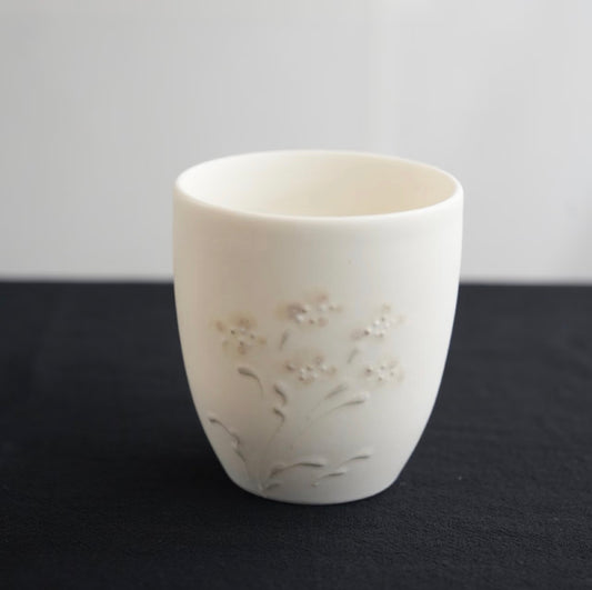 Kilnora Sōng Dandelion Series matte white ceramic cup showcasing delicate relief and minimalist design