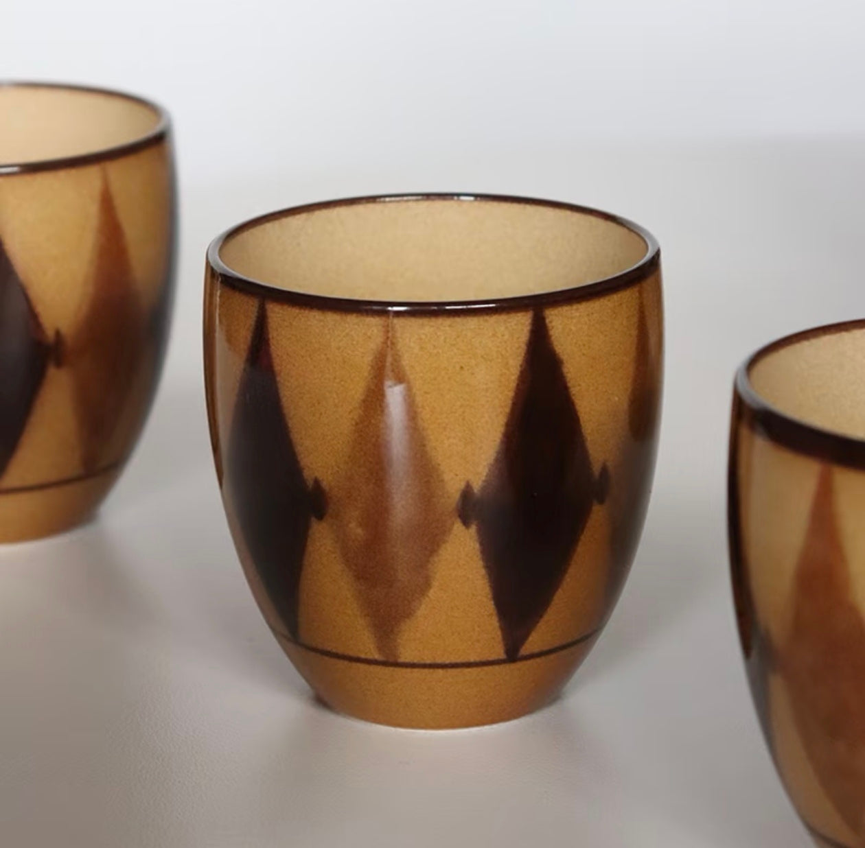 Kilnora Shisō diamond-shaped porcelain cup with geometric underglaze motifs