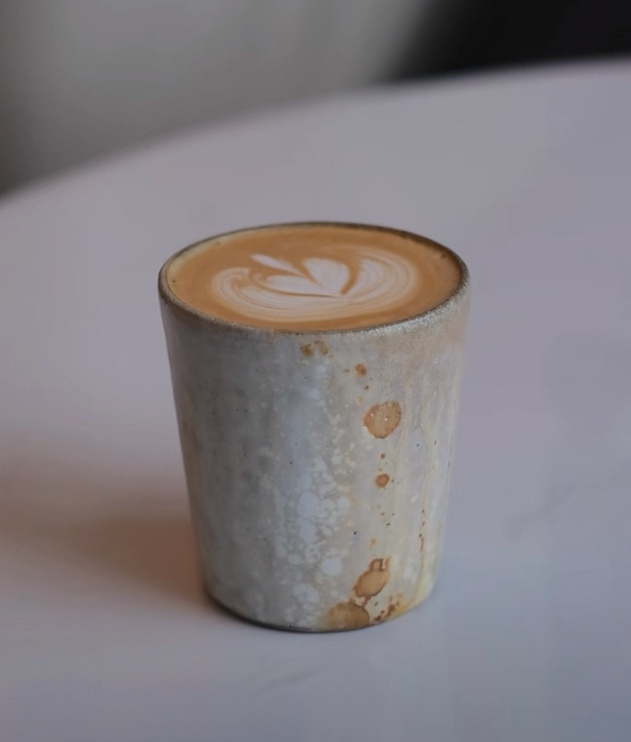 Kilnora Kyūshō Series white slip porcelain cup with straight sides and flame-textured rim.